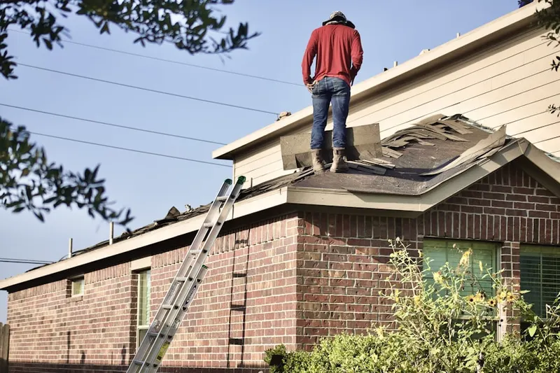 Professional roofer working on a residential roof in The Farms